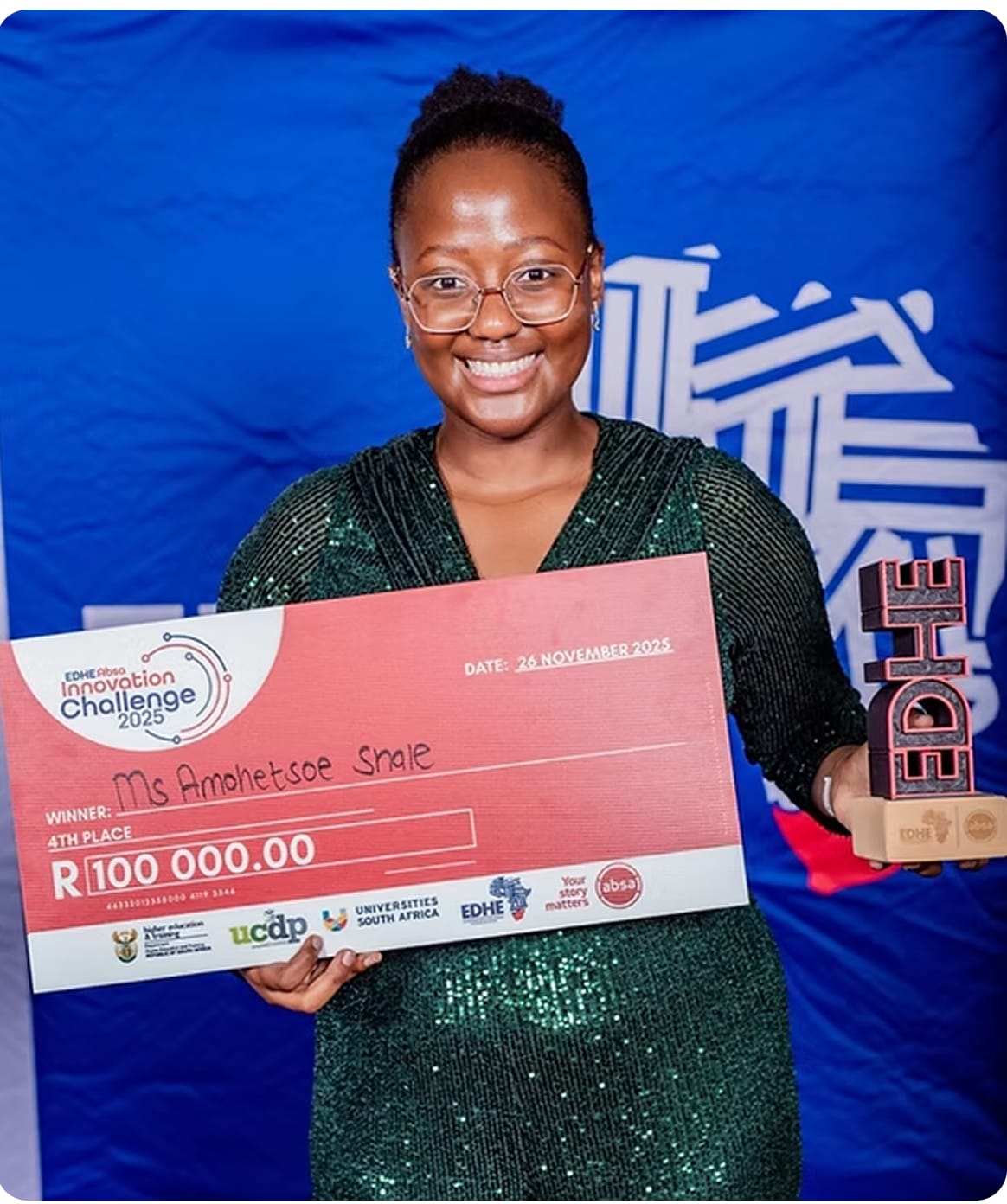 Amo Shale smiling with the EDHE Innovation Challenge prize cheque